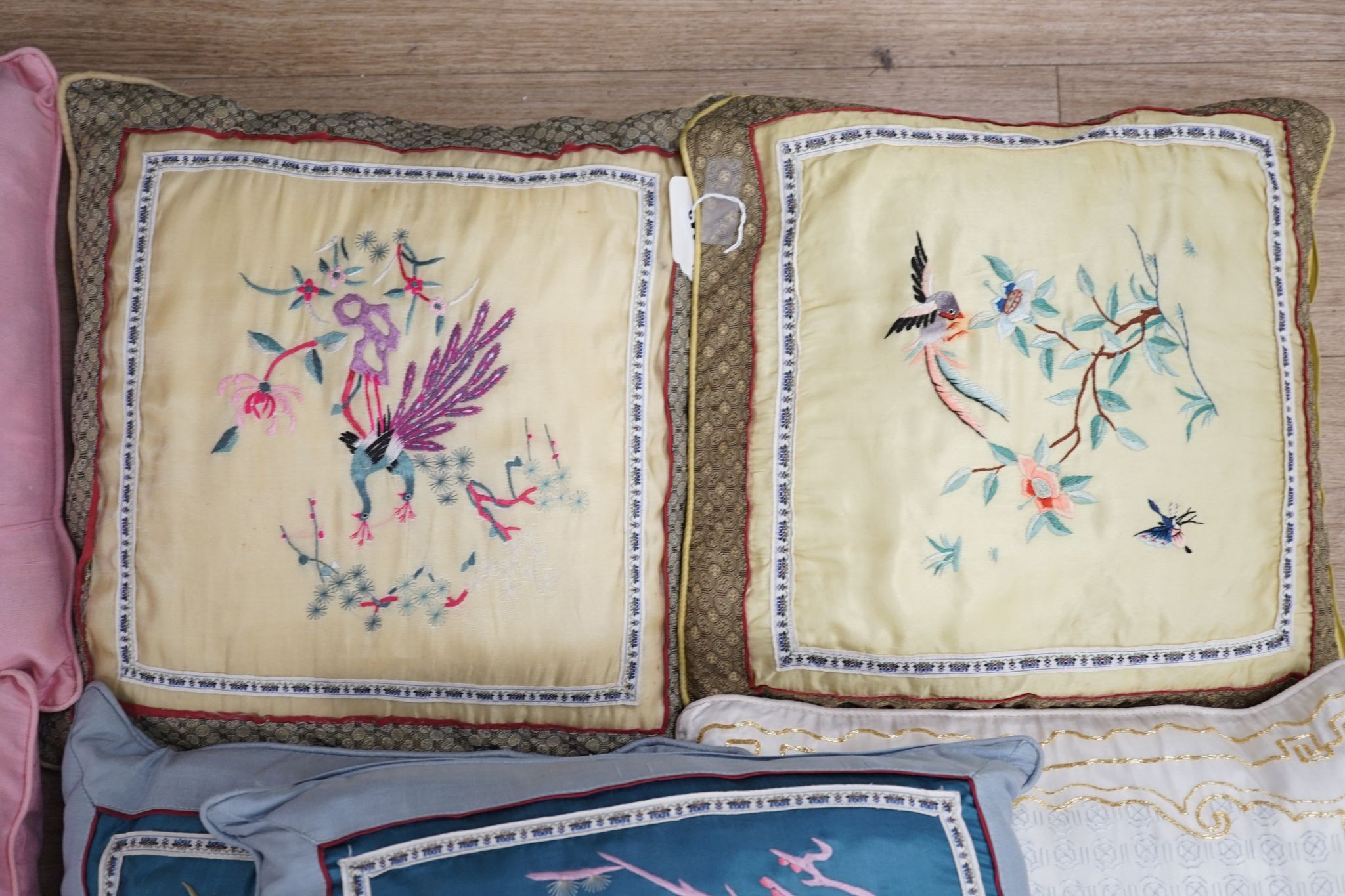 Three pairs of Chinese silk embroidered cushions and a cushion